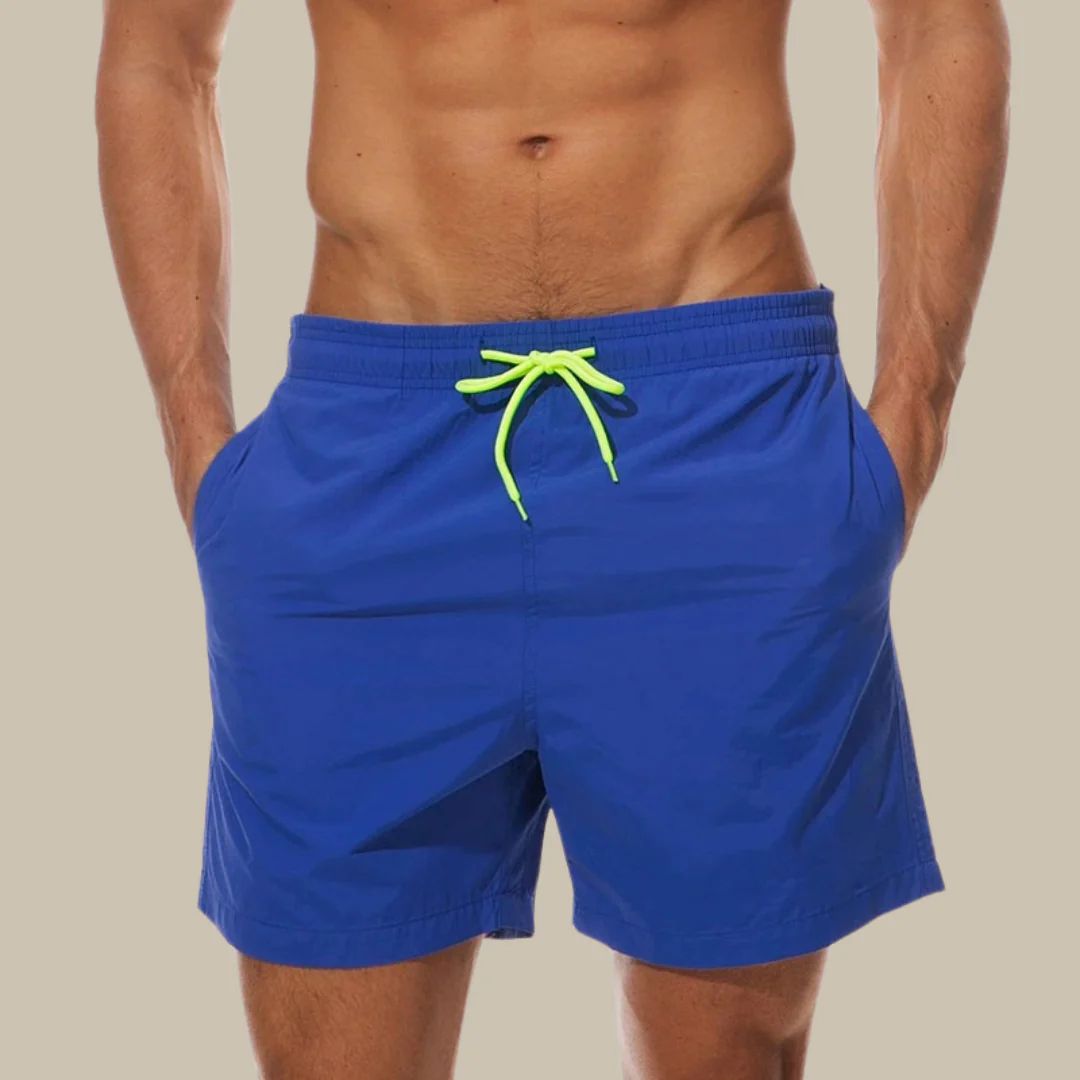 Quick-dry men's swimwear shorts for beach, pool, or vacation. Features comfy drawstring & pockets.