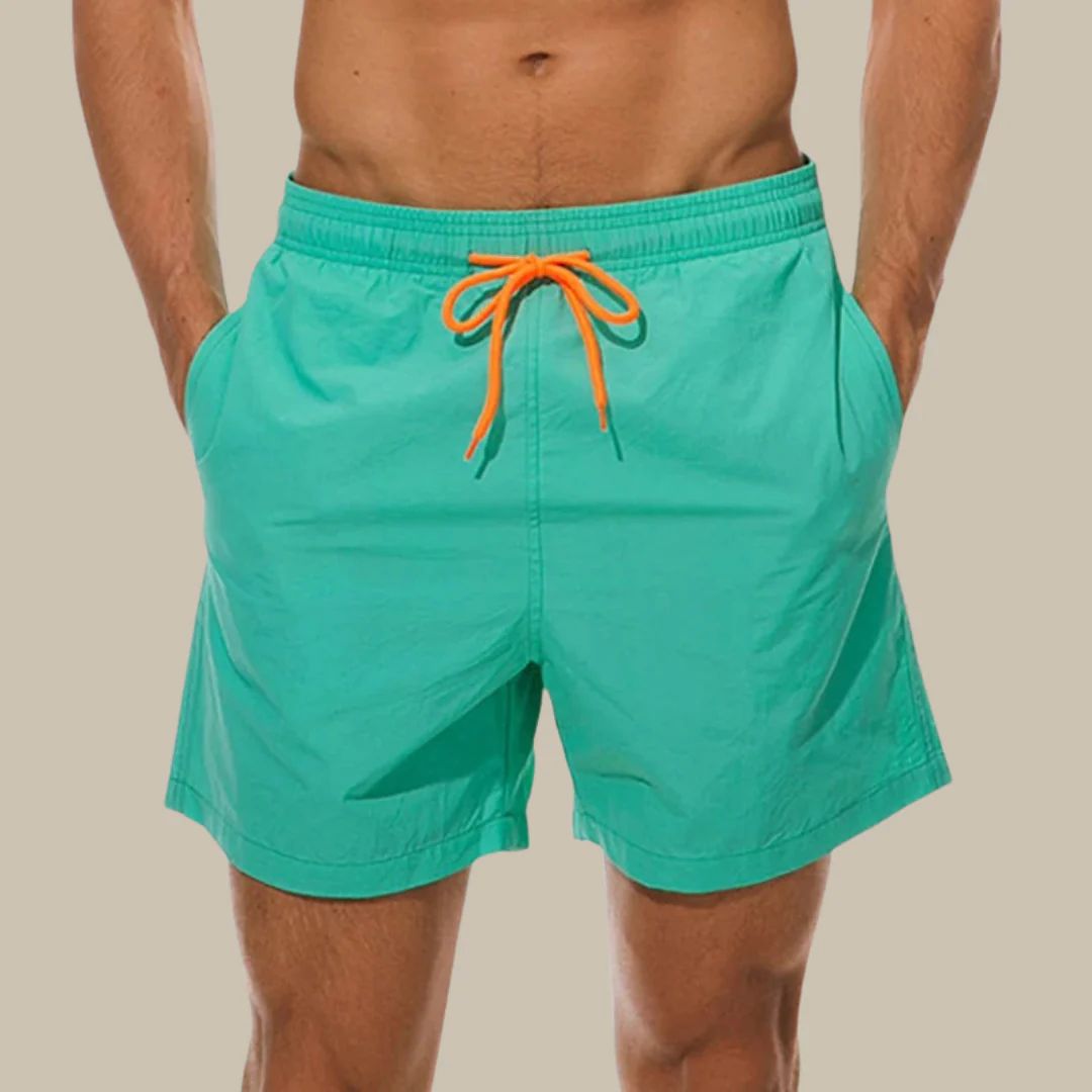 Stylish men's athletic swim shorts with practical side pockets & adjustable drawstring, perfect beachwear.