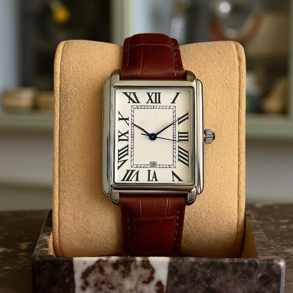 Close-up of men's classic square dress watch face, retro analog dial with an elegant, clear display.