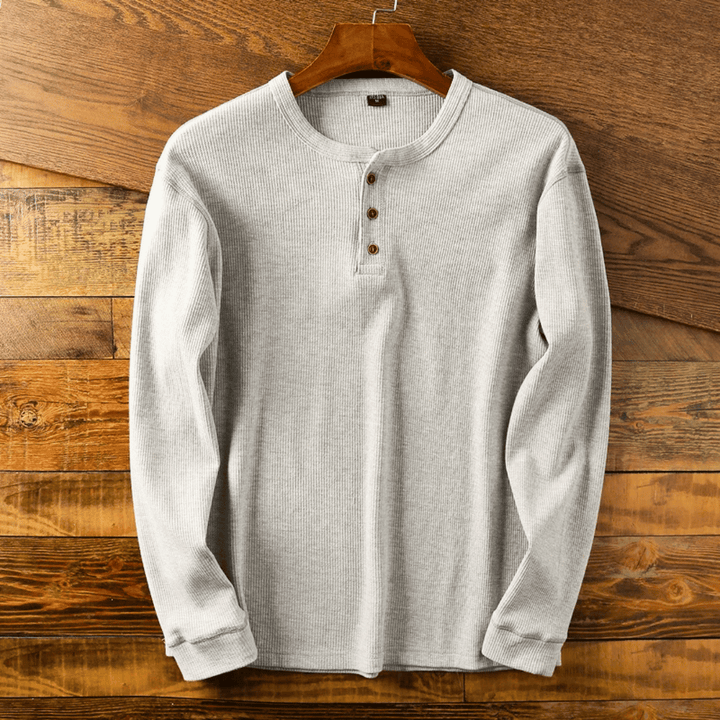 Men's comfort-fit long-sleeve henley shirt in soft fabric for everyday casual style.