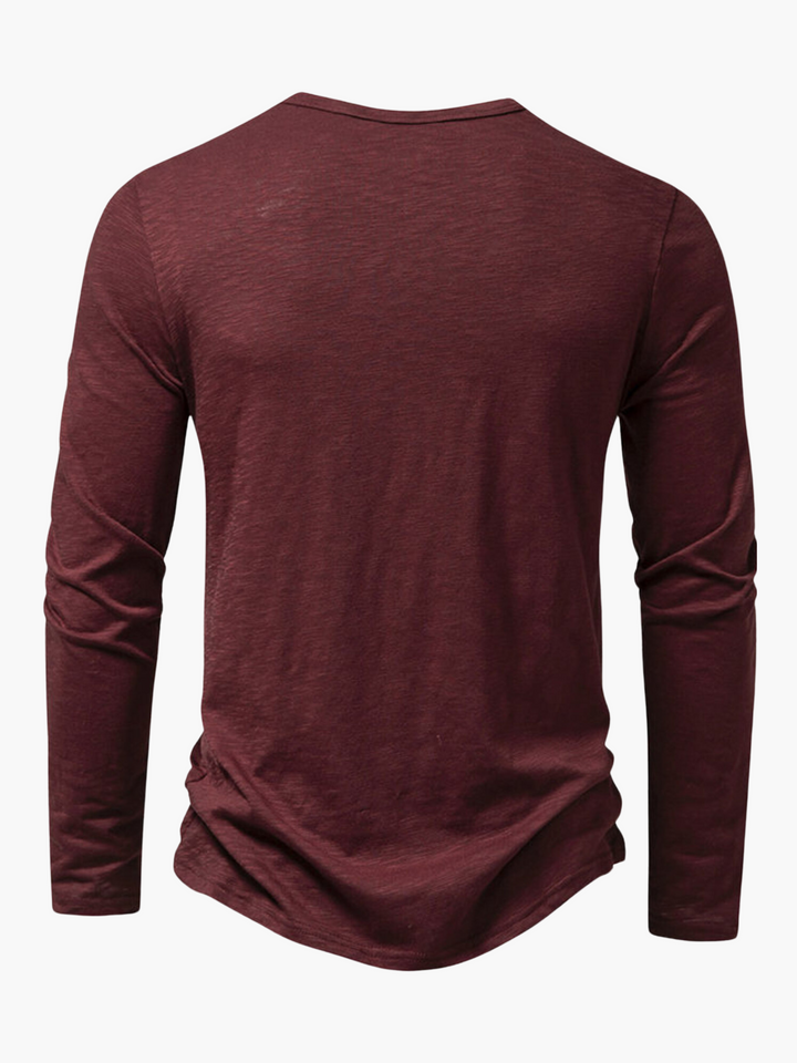 Front view of a men's Henley long sleeve t-shirt. Features button placket, relaxed fit, offering everyday comfort & style.