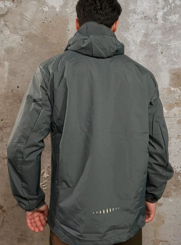 Weatherproof men's rain jacket with secure pockets, water-resistant & windproof for outdoor adventures.