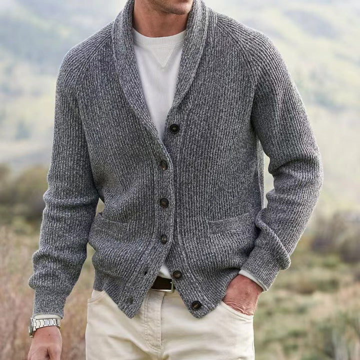 Warm men's knit sweater cardigan. Features a stylish shawl collar & convenient button front closure.