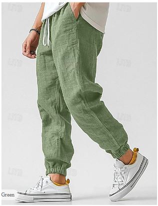 Model wearing men's green lightweight cargo pants, perfect for spring/summer casual wear & everyday utility.