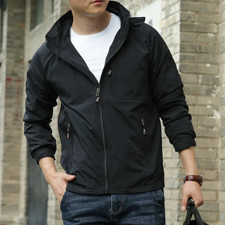 Full-body view of a man wearing a relaxed fit lightweight transitional jacket, ideal for casual spring & fall outfits.