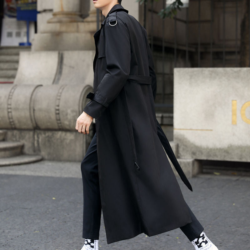 Fashionable men's long trench coat, double-breasted, with a sophisticated belted waist for outerwear.