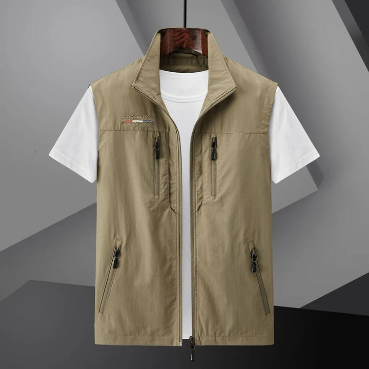 Back view of men's lightweight, breathable utility travel vest. Sleeveless design for summer outdoor adventures.