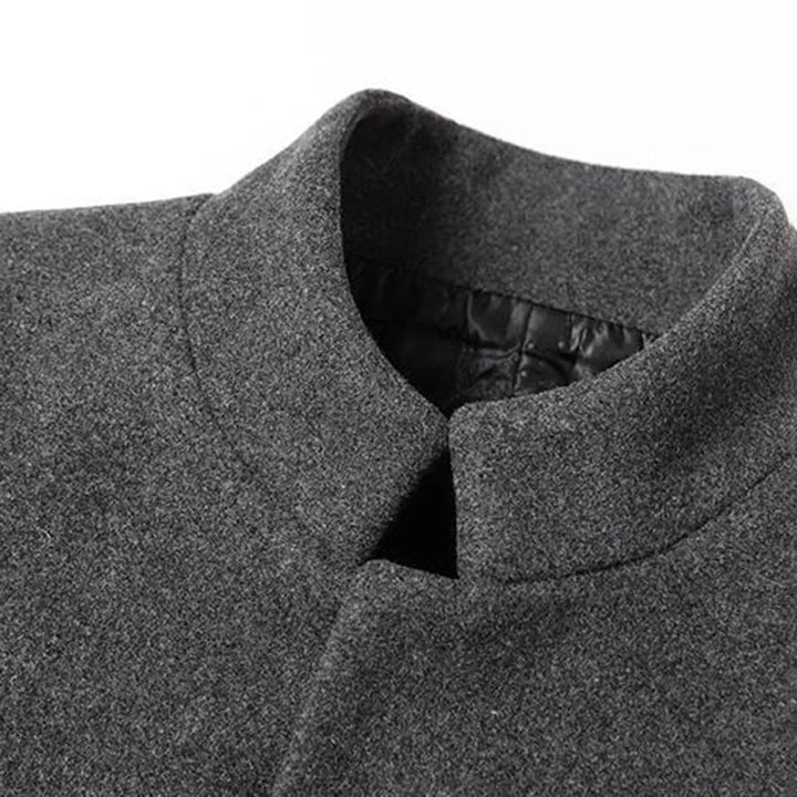 Warm men's formal long coat, ideal for winter. Shows a stylish man wearing the elegant button-down outerwear.