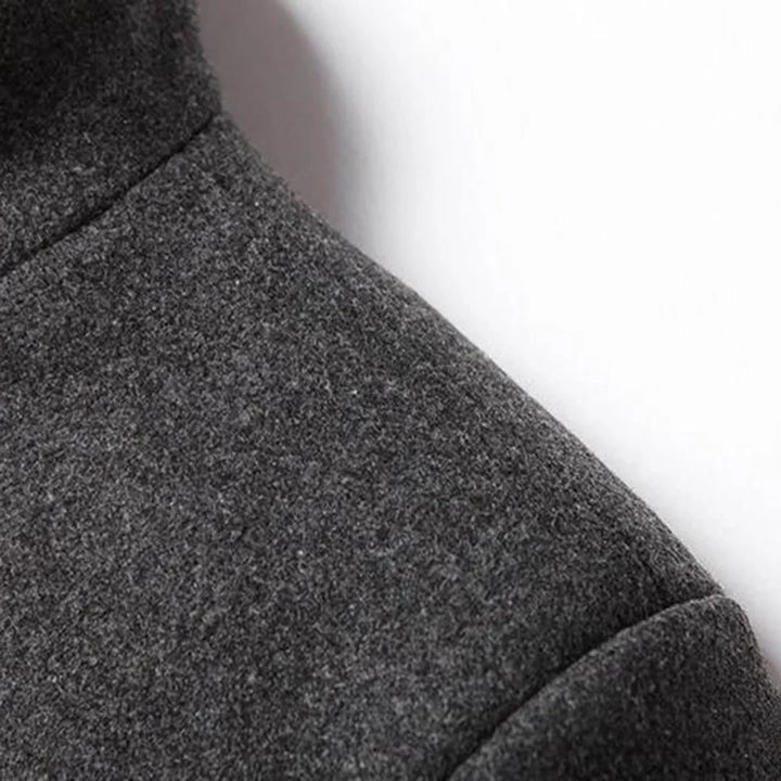Detail of new men's formal long coat: close-up on classic lapel collar, buttons, and quality fabric for winter.