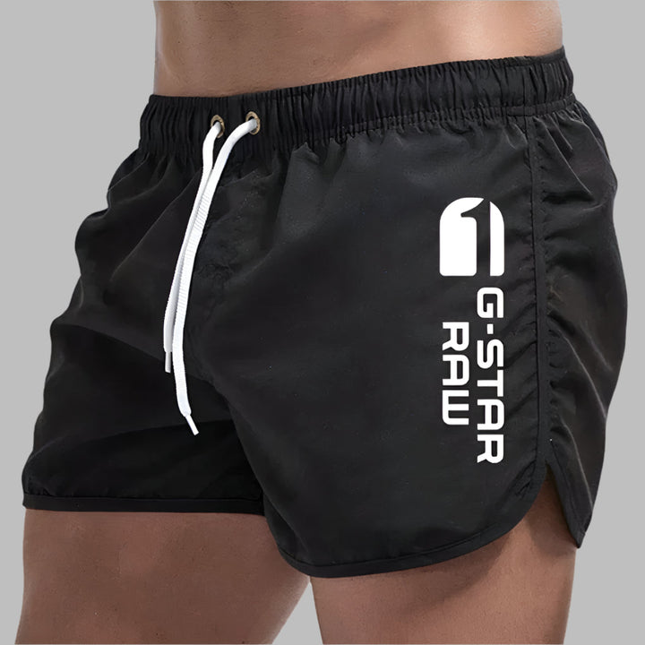 Solid color men's swim trunks made with quick-dry fabric. Perfect lightweight beach shorts for summer.