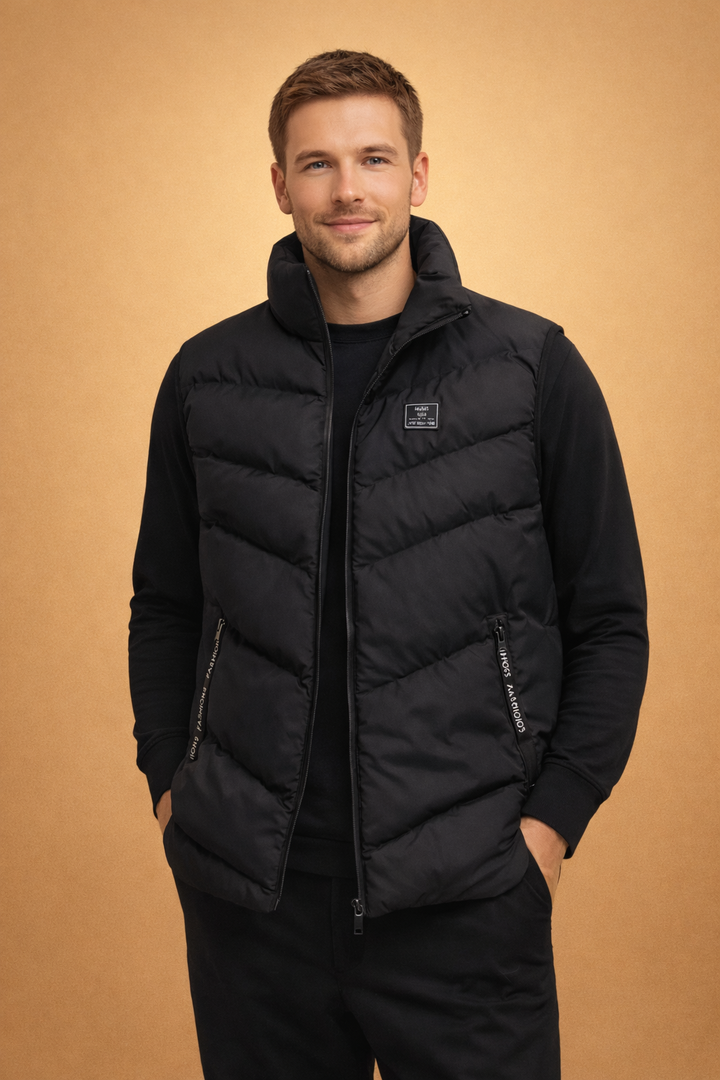 Stylish men's black quilted puffer vest, a warm layering piece for casual autumn & winter outfits.