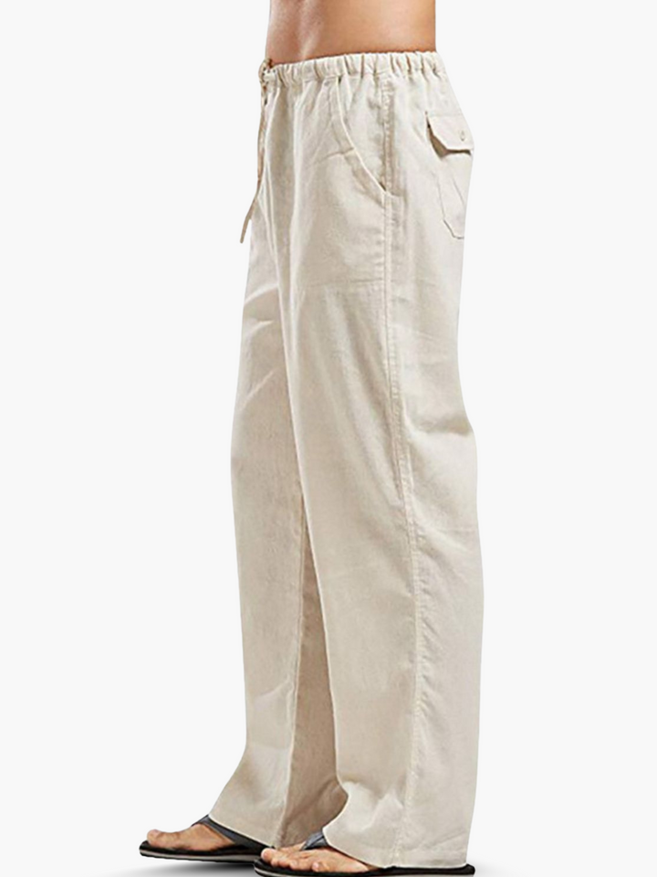 Relaxed fit men's drawstring pants, featuring an elastic waist and comfortable wide leg design for casual wear.
