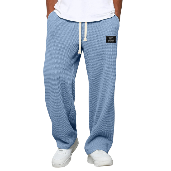 Men's relaxed fit jogging pants in soft grey fabric, perfect for comfort & casual style.