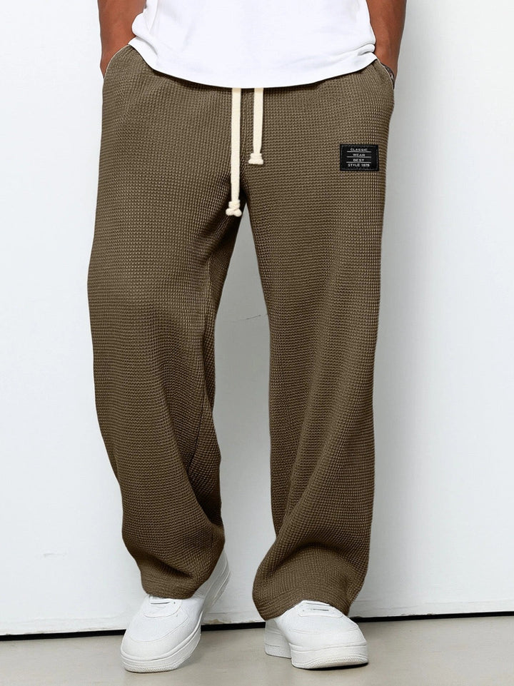 Comfortable men's lounge wear joggers, relaxed fit with elastic cuffs, perfect for home or errands.