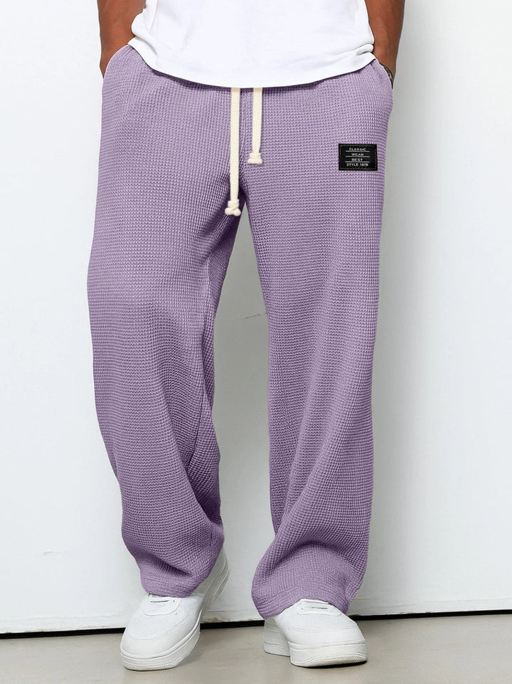 High-quality men's gym pants, relaxed fit sweatpants with drawstring, durable for intense workouts.