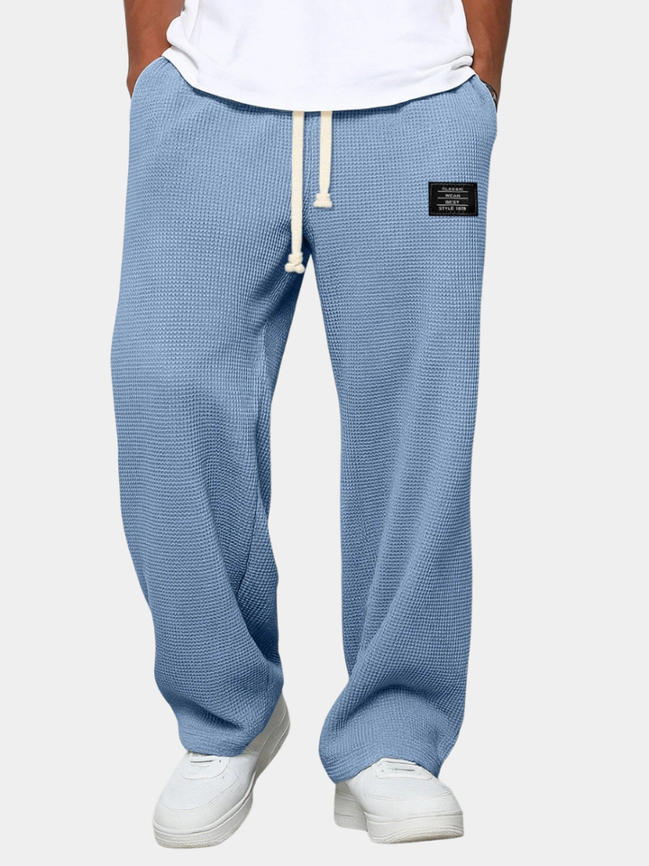 Comfortable men's black sweatpants with drawstring waist for ultimate lounge wear & activewear.