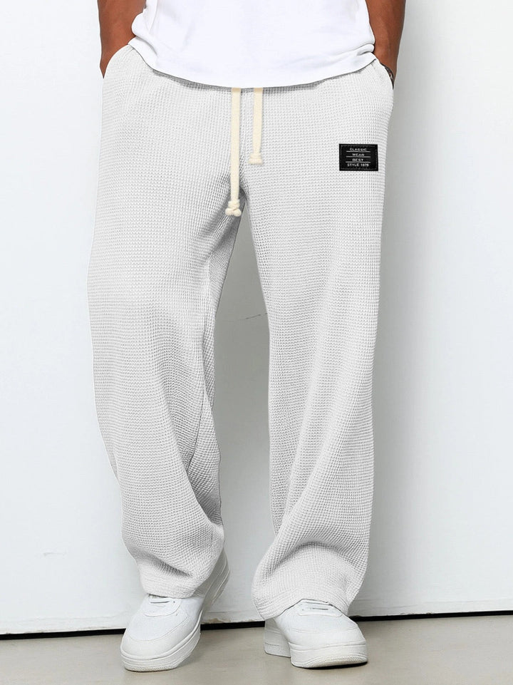 Grey men's activewear joggers, super comfortable with deep pockets, great for athletic and leisure.