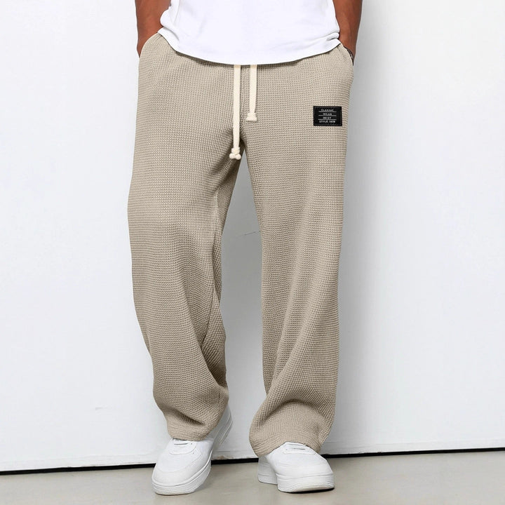 Dark blue men's jogging pants, relaxed fit design, perfect for gym, running, or casual lounge.