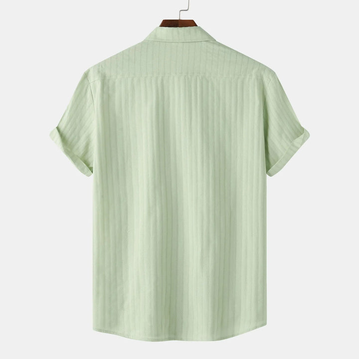 Casual men's short sleeve collared shirt. Button-down design offers comfort & smart casual style.