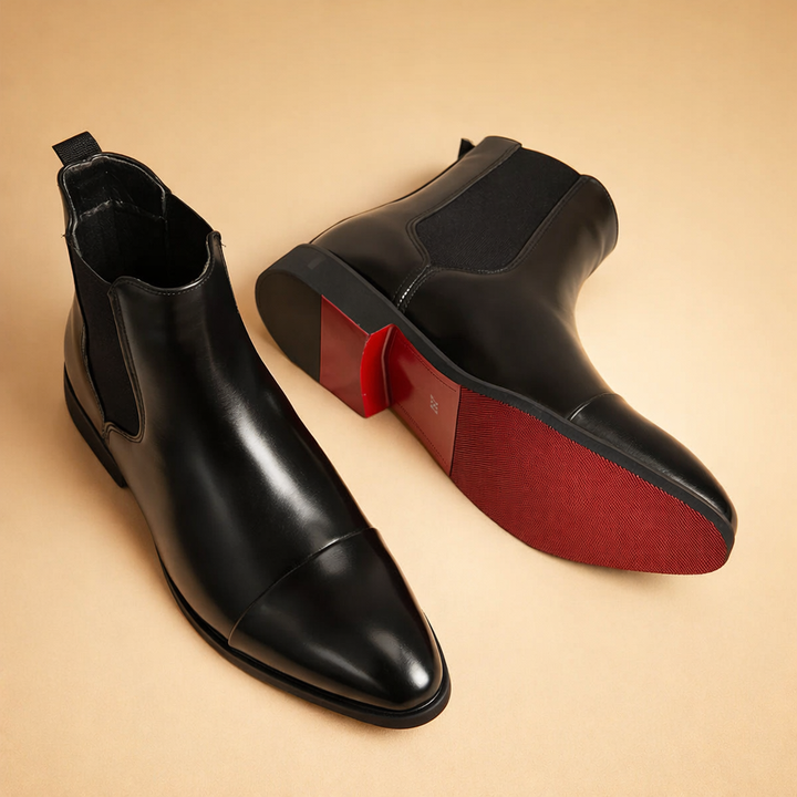 Men's sleek black leather slip-on Chelsea boots with refined cap toe, perfect for everyday and formal style.