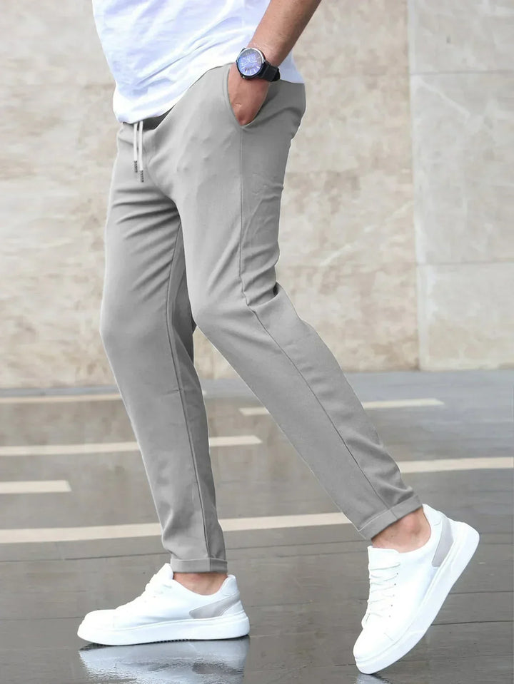 Stylish men's slim-fit pants offering flexible comfort for both office and casual occasions.
