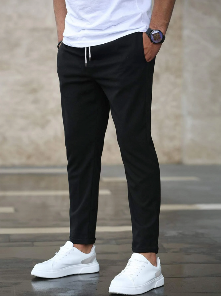 Back view of men's modern slim-fit pants, showcasing durable fabric and comfortable flexibility.