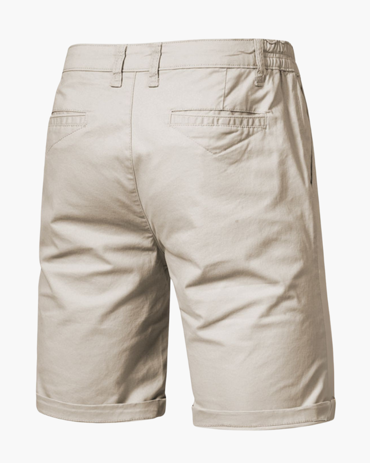 Detailed view of durable button & zipper closure on men's tailored chino shorts, perfect for smart casual summer style.