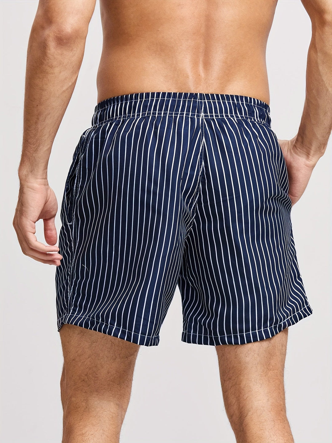Comfortable men's striped swim shorts featuring a functional drawstring waist. Great for swimwear & beach.