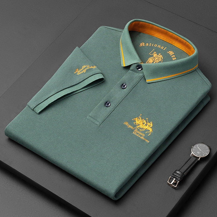 Man wearing a trendy men's short sleeve polo with stylish embroidery. Ideal for a summer fashion outing.