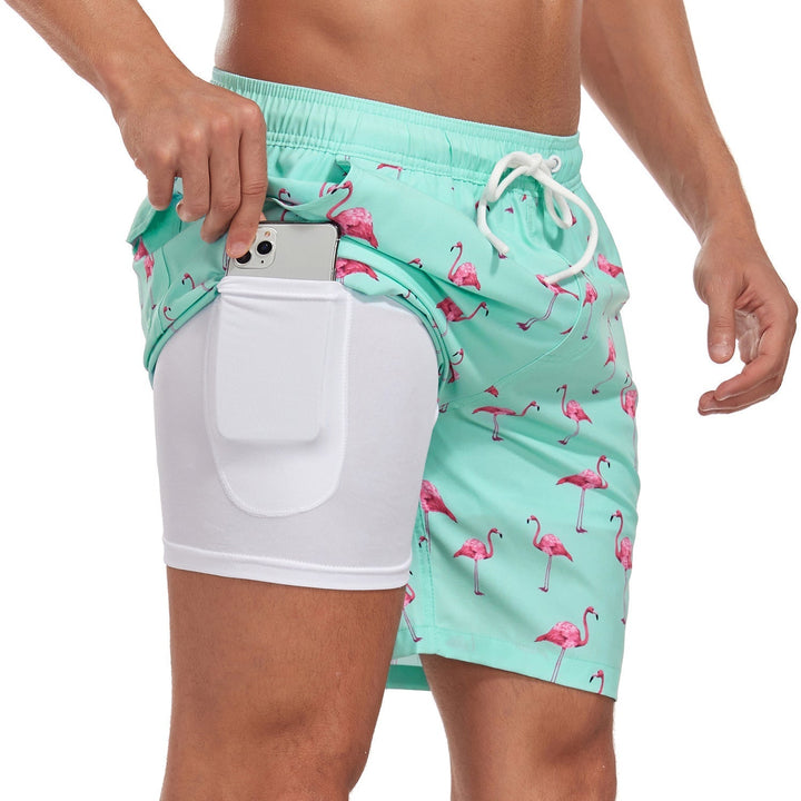 Close-up of men's printed swim shorts showing drawstring and vibrant pattern, stylish summer attire.