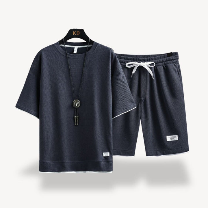 "Men wearing dark gray cotton jersey shorts set, showcasing relaxed fit and minimalist design for casual comfort"