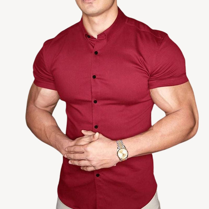 "Men's black muscle fit shirt, cotton spandex, short sleeve, highlighting athletic build, ideal for versatile styling."