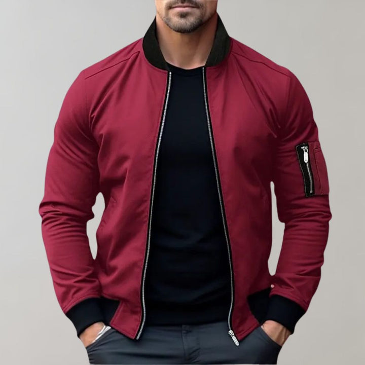 "Men's blue bomber jacket with zipper pockets, stylish fit, lightweight fabric, perfect for cool evenings."