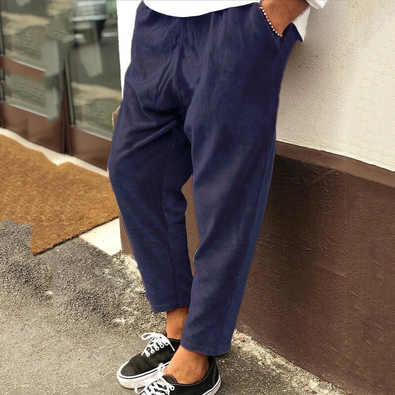 Men's corduroy trousers in green, side view showcasing casual elegance, perfect for versatile styling and comfort.