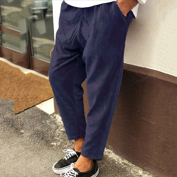 Men's corduroy trousers in green, side view showcasing casual elegance, perfect for versatile styling and comfort.
