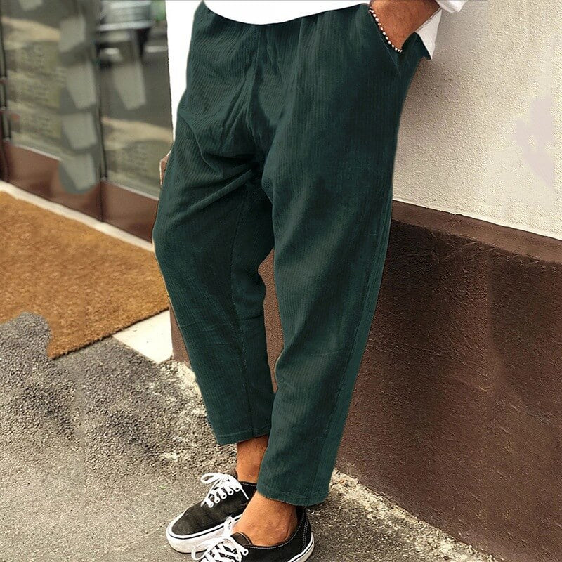 Men's corduroy trousers in green, side view showcasing casual elegance, perfect for versatile styling and comfort.