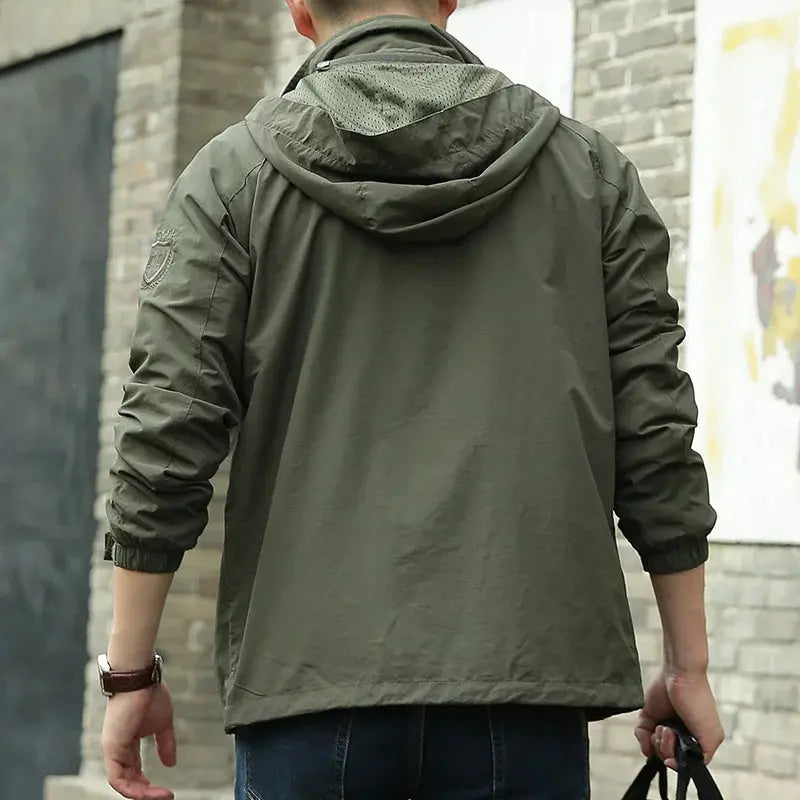 Men's lightweight breathable all-season jacket, sleek design, dark color, highlighting its comfort and versatility for layeri