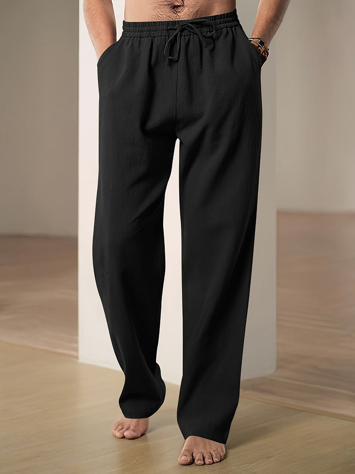"Men's lightweight relaxed fit lounge trousers with drawstring waist, breathable fabric, shown in stylish grey tone."