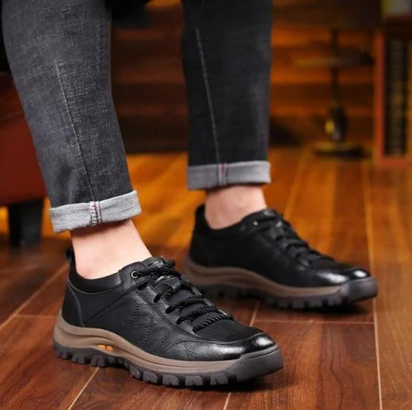 Men's black orthopedic shoe showing waterproof feature