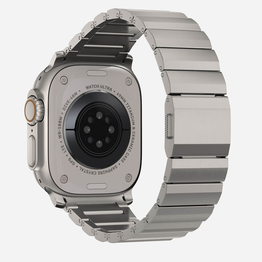 Men's sleek titanium watch band with shiny finish, magnetic clasp, durable and lightweight; perfect for daily or formal wear.