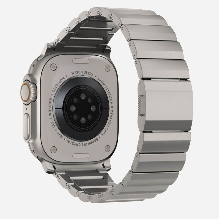 Men's sleek titanium watch band with shiny finish, magnetic clasp, durable and lightweight; perfect for daily or formal wear.