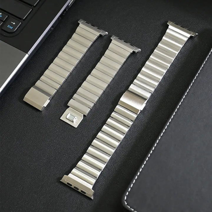 Men's sleek titanium watch band with shiny finish, magnetic clasp, durable and lightweight; perfect for daily or formal wear.