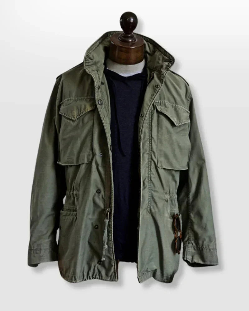 Men's vintage cotton field jacket with adjustable waist, rugged design, breathable fabric, suitable for layering.