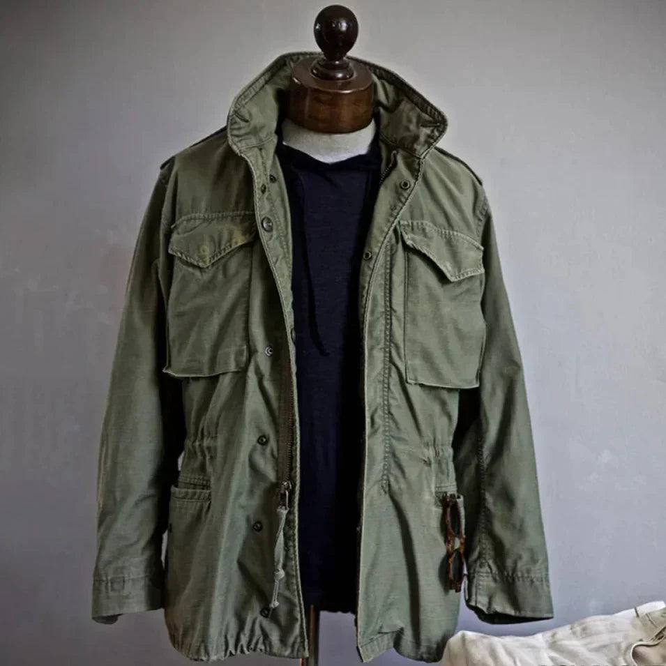 Men's vintage cotton field jacket with adjustable waist, rugged design, breathable fabric, suitable for layering.
