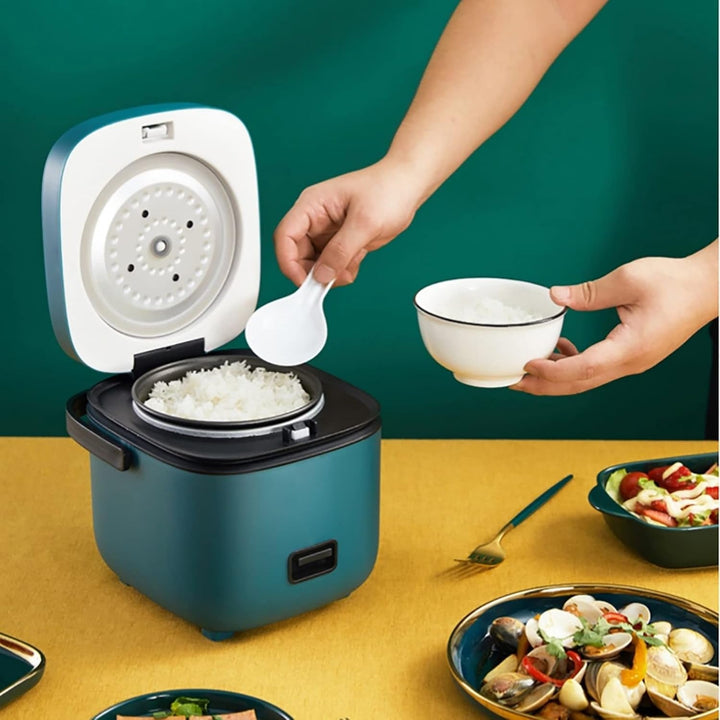"Mini rice cooker and steamer, compact design for 1-2 people, 1.2L capacity, in green, ideal for small kitchens or travel."