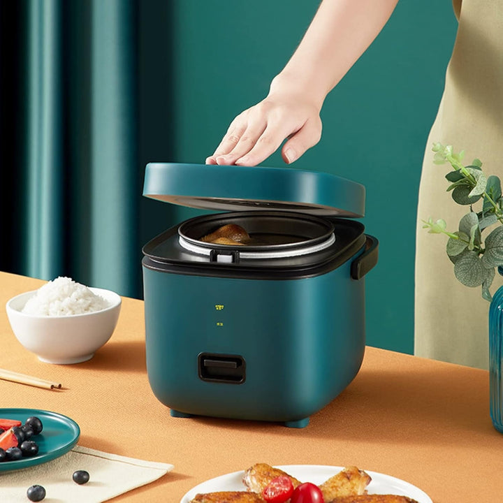 "Mini rice cooker and steamer, compact design for 1-2 people, 1.2L capacity, in green, ideal for small kitchens or travel."