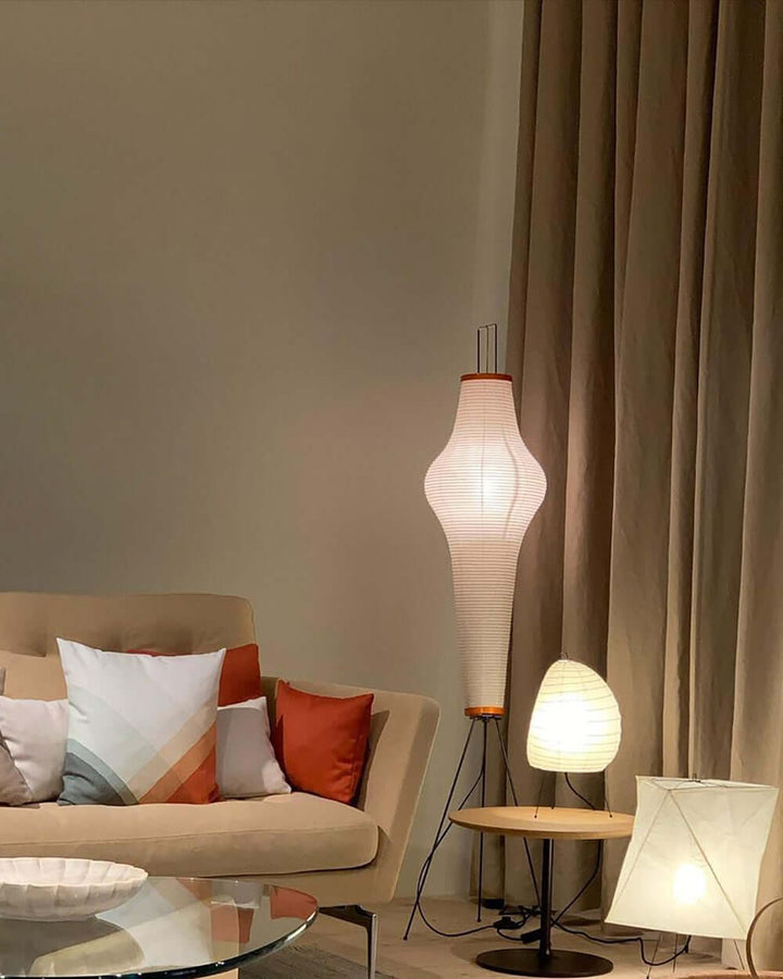 "Minimalist rice paper floor lamp with sleek metal frame and soft diffused light, perfect for creating a warm ambiance."