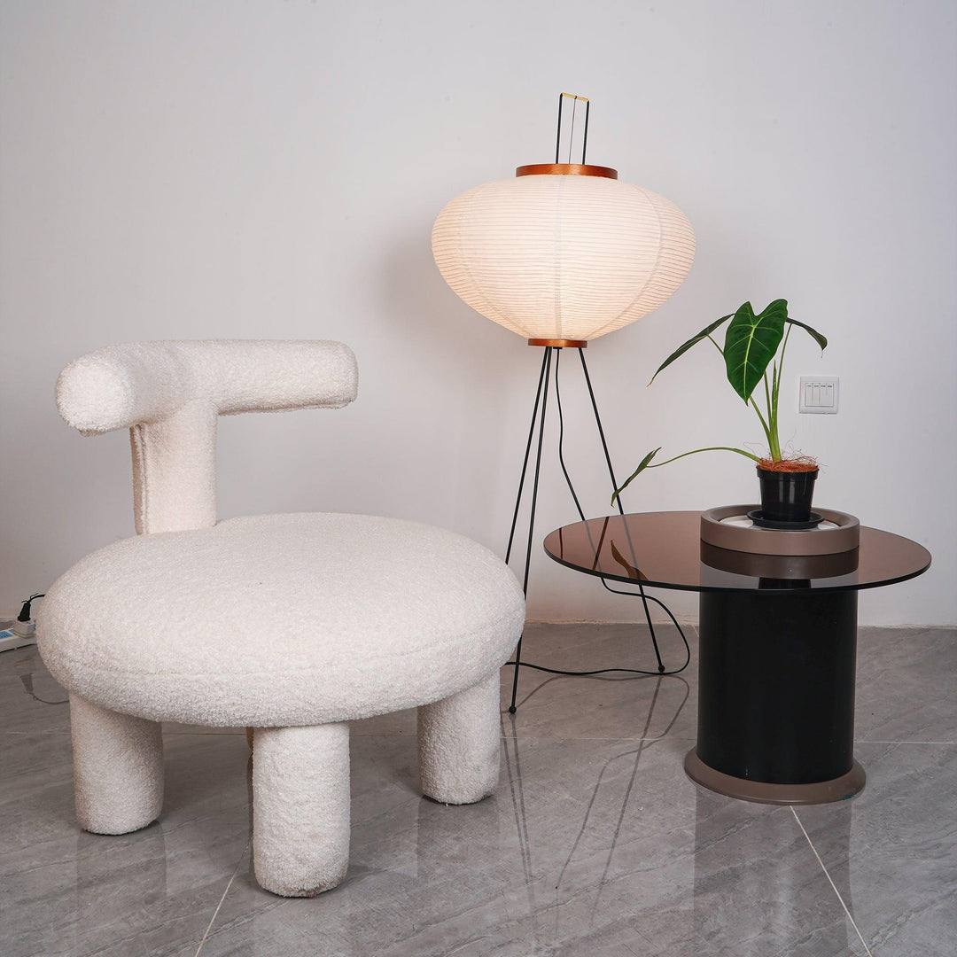 "Minimalist rice paper floor lamp with sleek metal frame and soft diffused light, perfect for creating a warm ambiance."