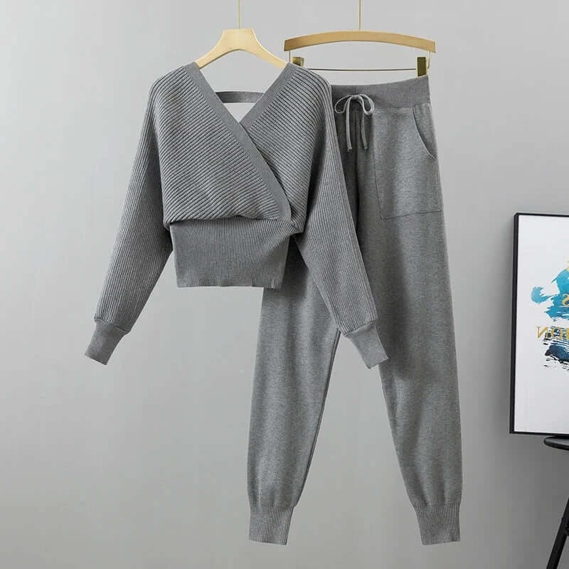 Elegant women's two-piece ribbed knit set with V-neck top and loose-fit harem pants in white.