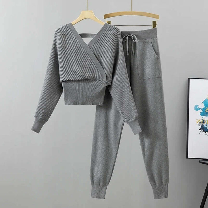 Elegant women's two-piece ribbed knit set with V-neck top and loose-fit harem pants in white.